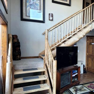 TV and Stairway to Room 3,4, & 5 at Cucharas River Bed and Breakfast